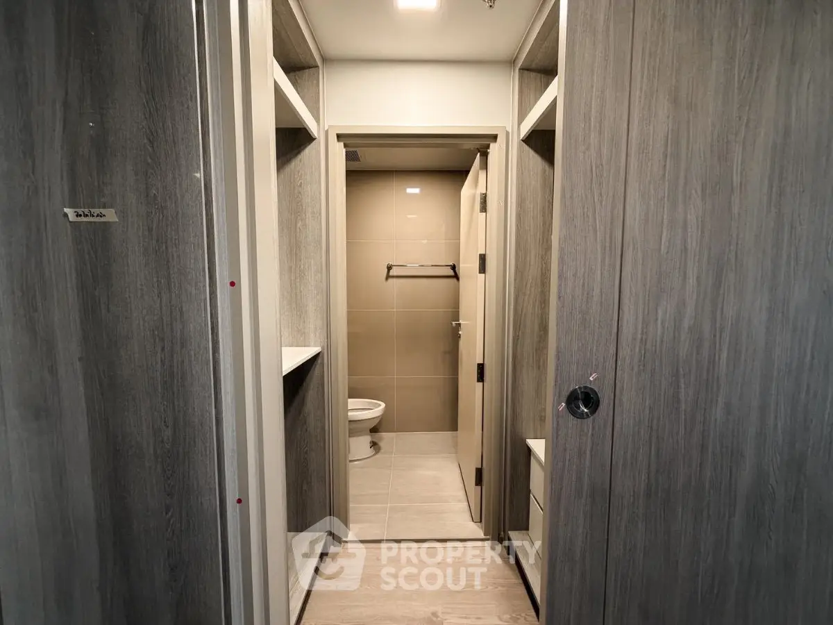 Modern bathroom with sleek wooden cabinetry and neutral tile design