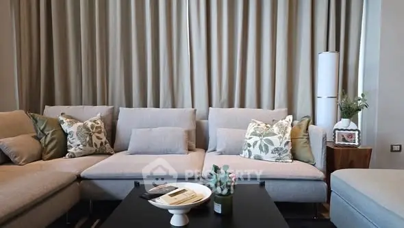 Stylish living room with modern gray sofa and decorative pillows