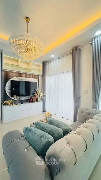Luxurious living room with elegant chandelier and plush seating