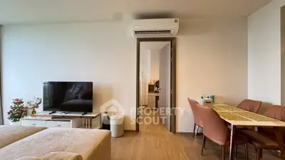 Modern living room with stylish dining area and air conditioning, perfect for comfortable living.