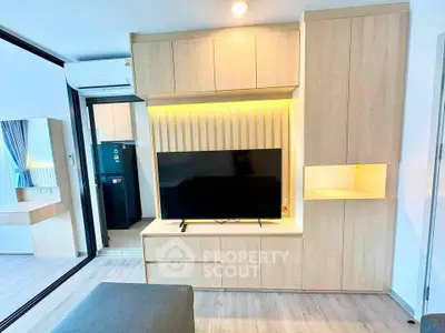 Modern living room with built-in wooden TV cabinet and ambient lighting
