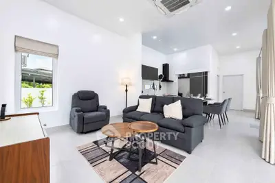 Spacious modern living room with elegant furniture and open kitchen layout