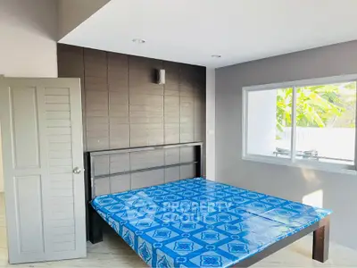 Spacious bedroom with modern design and large window for natural light