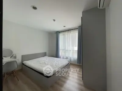 Modern minimalist bedroom with natural light and sleek furnishings