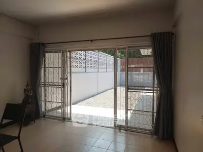 Spacious room with sliding glass doors leading to a private outdoor area.