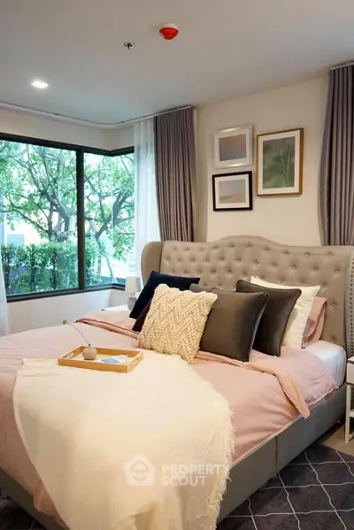 Luxurious bedroom with plush bed and large window view