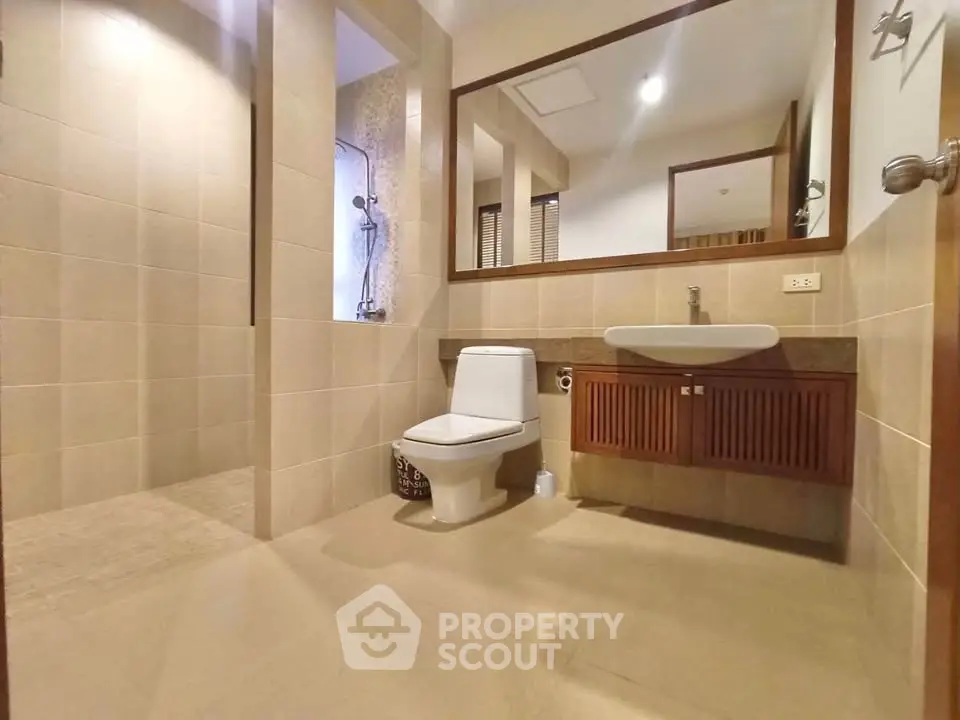 Spacious modern bathroom with walk-in shower and elegant fixtures.