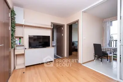 Modern living room with TV and dining area in open layout apartment