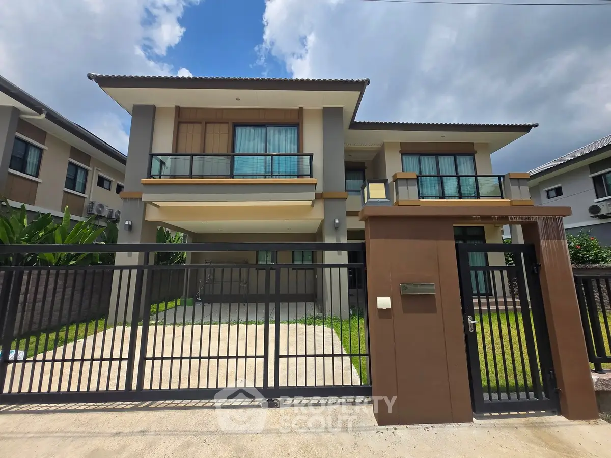 Modern two-story house with gated entrance and spacious driveway in a suburban neighborhood.