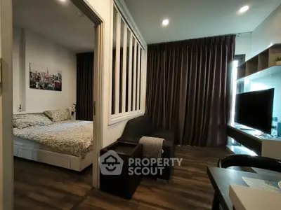 Modern studio apartment with cozy bedroom and stylish living area, featuring elegant decor and ample natural light.