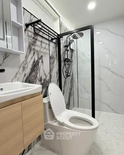 Modern bathroom with marble walls and sleek shower design