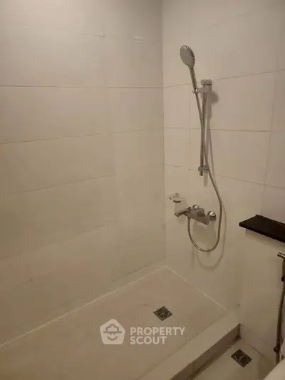 Modern bathroom with sleek shower fixtures and minimalist design.