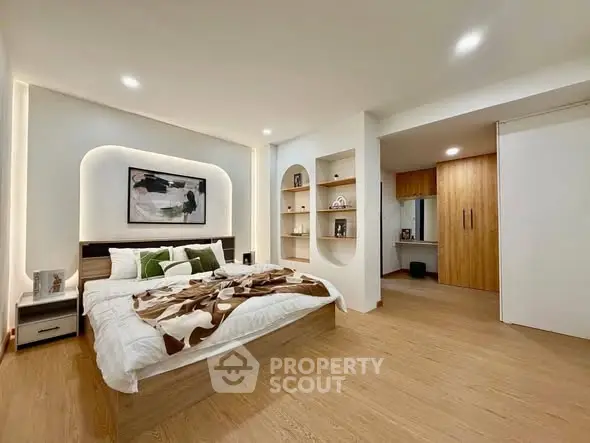 Spacious modern bedroom with elegant decor and ample storage space