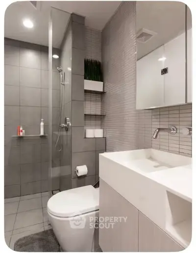 Modern bathroom with sleek design, glass shower, and contemporary fixtures.