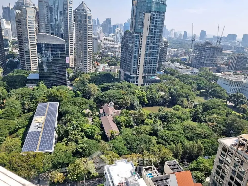 Stunning aerial view of urban skyline with lush green park and modern high-rise buildings.