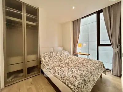 Cozy bedroom with modern wardrobe and large window for natural light