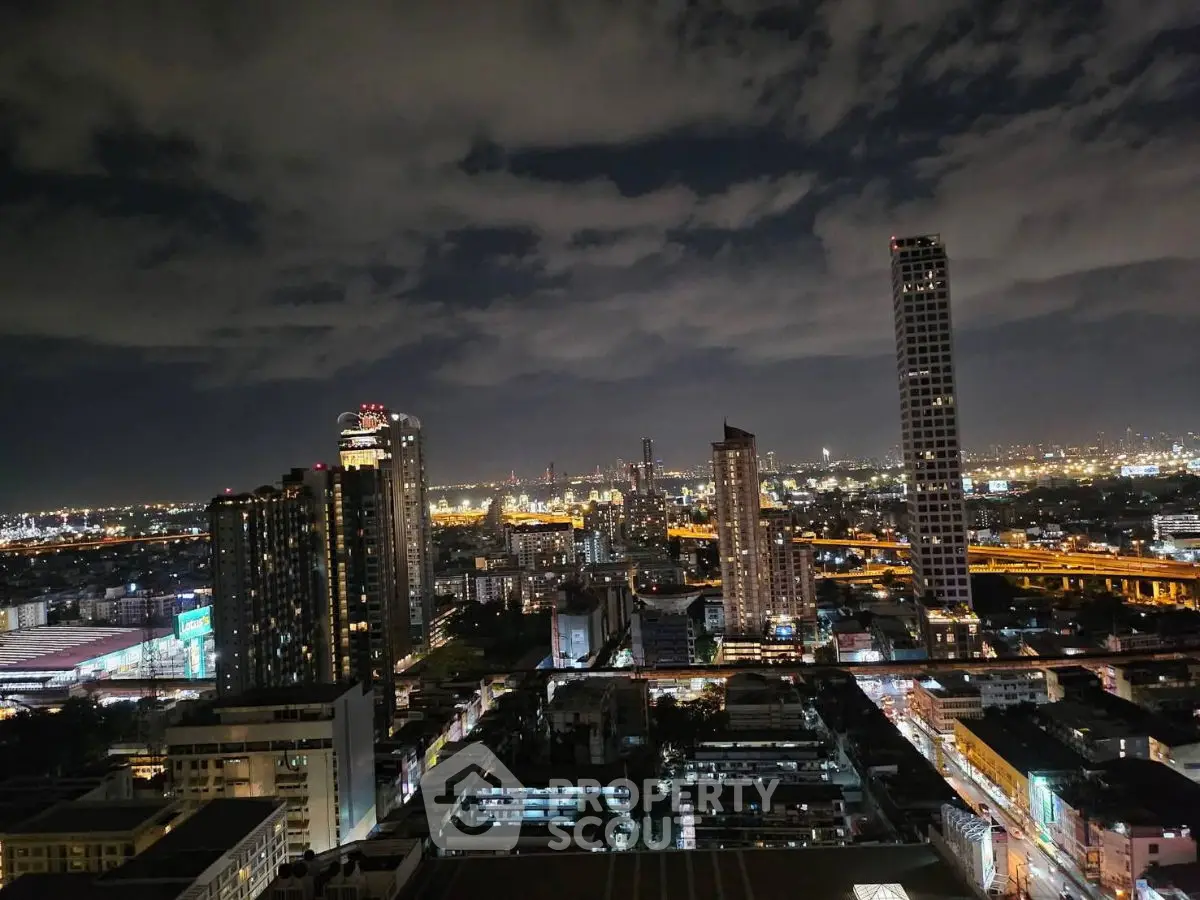 Stunning cityscape view from high-rise building at night with illuminated skyline.