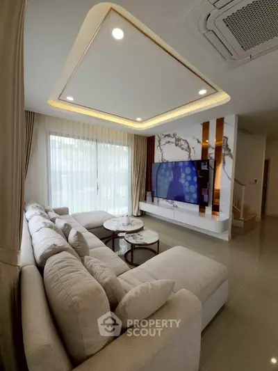 Luxurious living room with modern decor and large sectional sofa, perfect for relaxation.