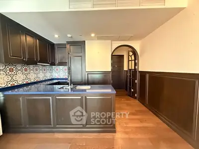 Elegant kitchen with dark wood cabinets and stylish backsplash