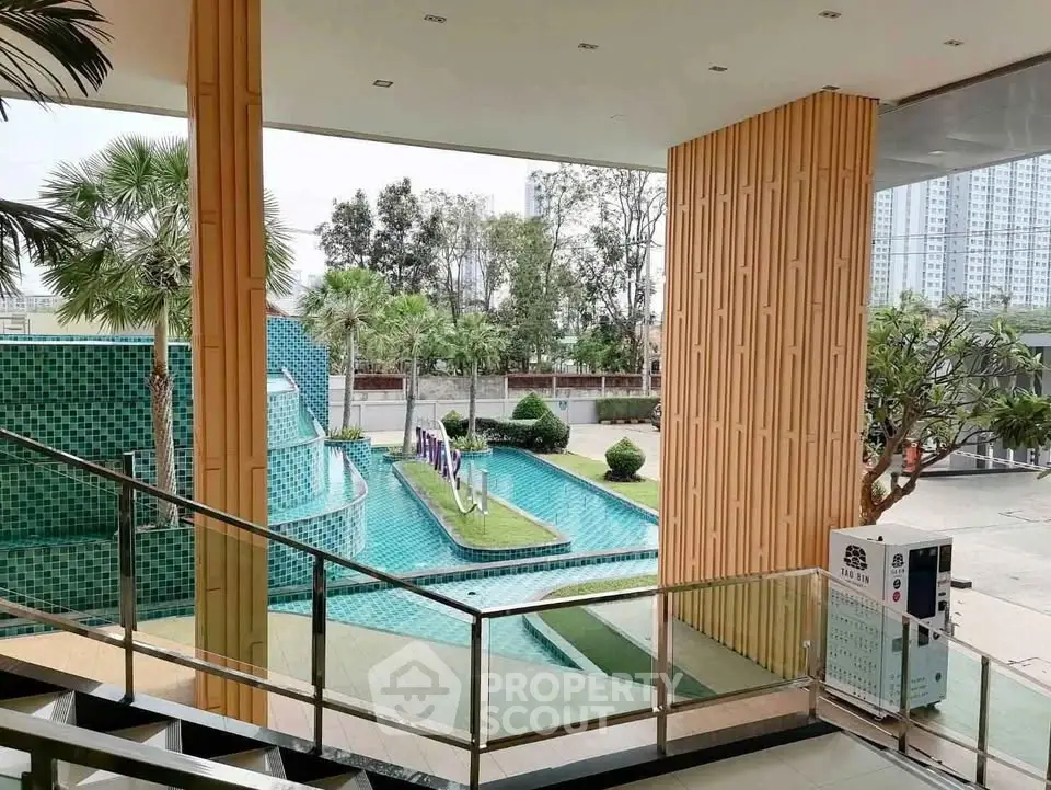 Luxurious poolside view with modern architecture and lush greenery