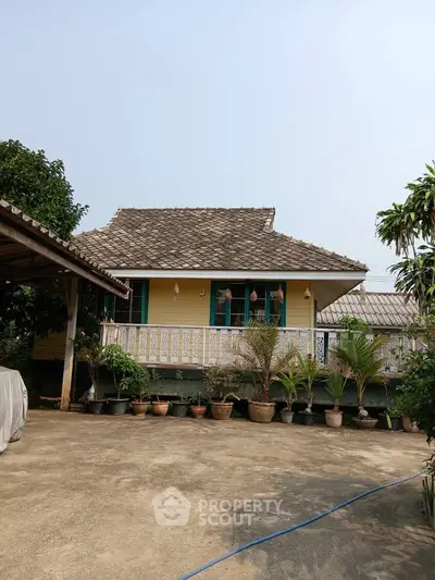Charming yellow house with lush garden and spacious patio