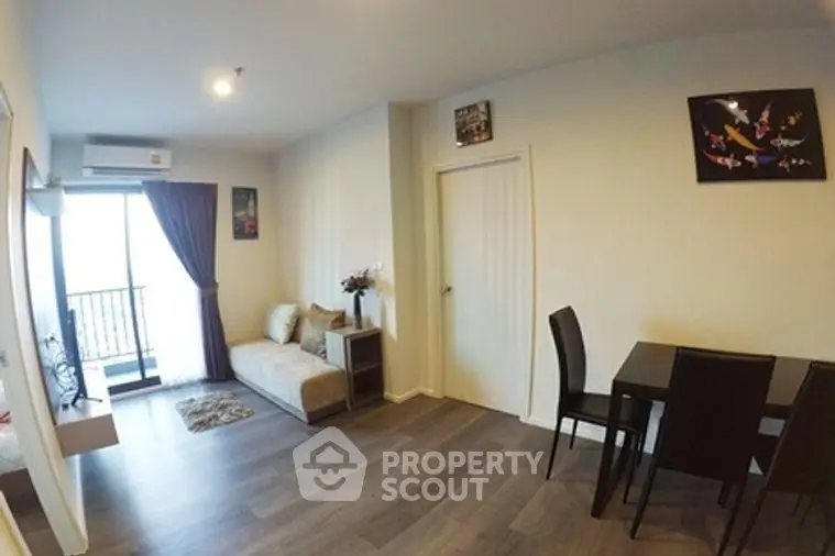 Modern living room with stylish decor and balcony access in a contemporary apartment.