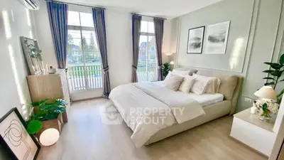 Spacious and bright bedroom with large windows and elegant decor