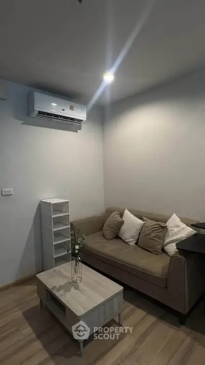 Cozy living room with modern air conditioning and stylish furniture, perfect for relaxation.