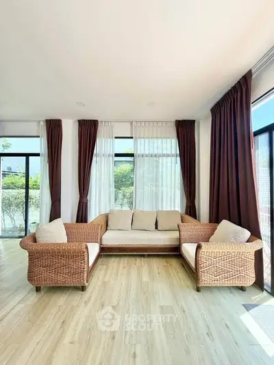 Bright and airy living room with wicker furniture and large windows