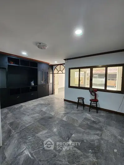 Spacious living room with modern design and ample natural light