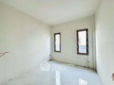 Spacious unfurnished room with large windows and white tiled flooring, ideal for customization.