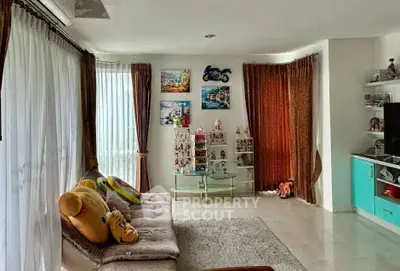 Spacious living room with cozy seating and large windows for natural light.