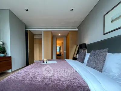 Luxurious bedroom with plush bedding and modern decor in a stylish apartment.