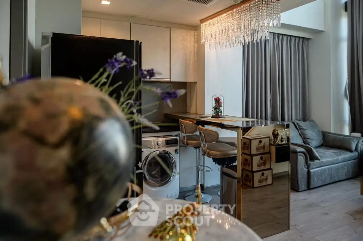 Luxurious modern living room with open kitchen and elegant chandelier