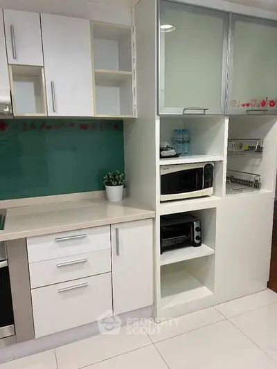 Modern kitchen with sleek white cabinetry and built-in appliances