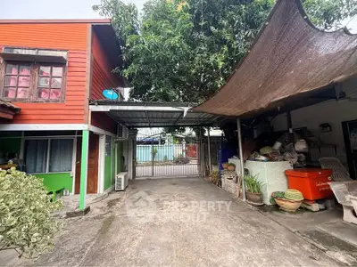 Charming residential property with spacious driveway and covered outdoor area, perfect for family gatherings.