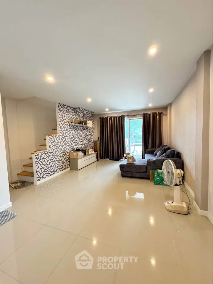 Spacious living room with modern decor and natural light