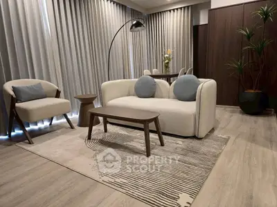 Modern living room with stylish furniture and elegant decor, featuring a cozy sofa and chic armchair.