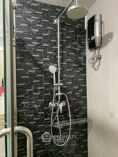 Modern bathroom shower with sleek black tile and water heater