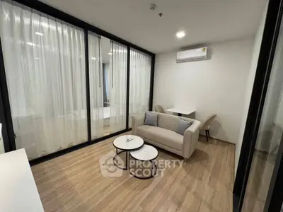 Modern living room with sleek design, featuring a cozy sofa and stylish coffee tables, perfect for relaxation.