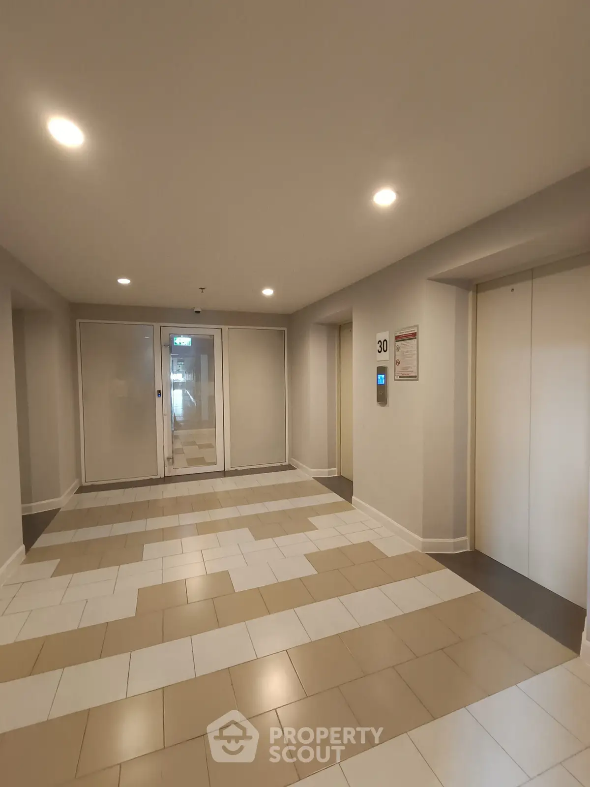 Modern building corridor with elevators and stylish tile flooring