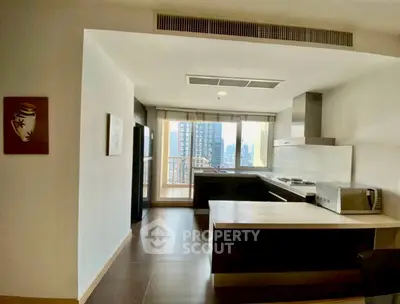 Modern kitchen with open layout and city view, featuring sleek appliances and stylish design.