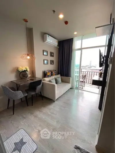 Chic modern living room with balcony view, stylish decor, and cozy seating area.
