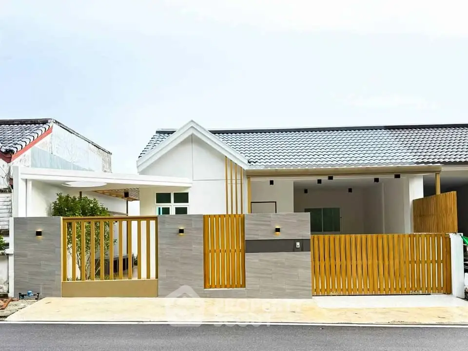 Modern single-story house with stylish wooden fence and contemporary design.