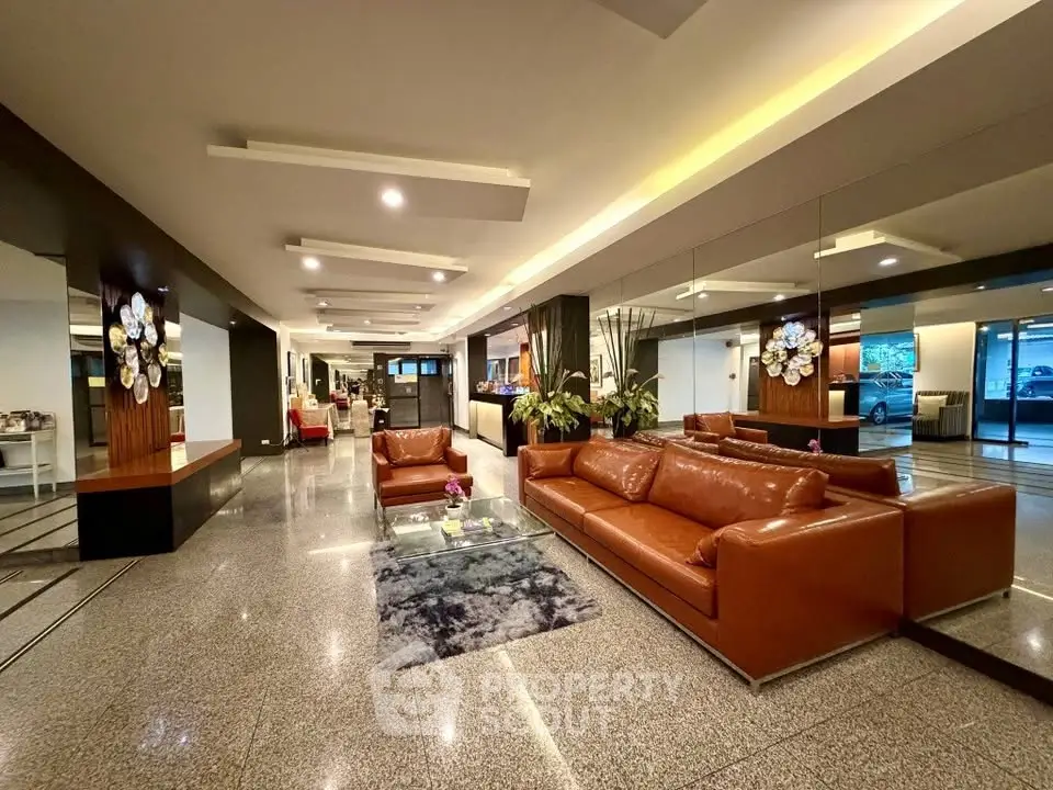 Luxurious lobby with modern leather seating and elegant decor in upscale building