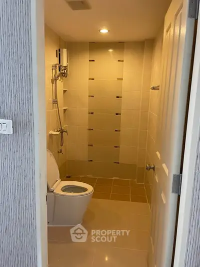 Modern bathroom with tiled walls and shower in a real estate property