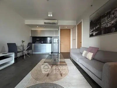 Modern living room with sleek kitchen and stylish decor