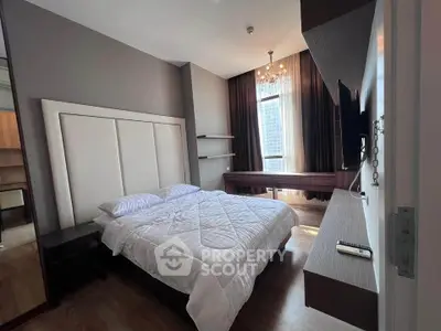 Luxurious bedroom with modern decor and large window offering city view