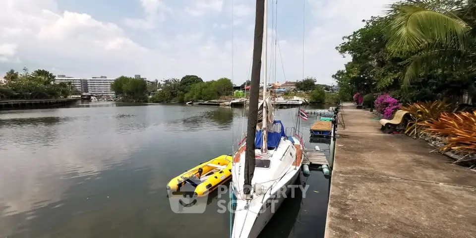Scenic waterfront view with boats and lush greenery, perfect for tranquil living.
