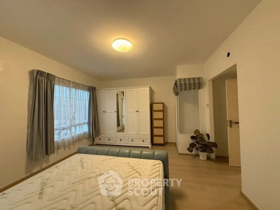 Spacious bedroom with modern furniture and natural light